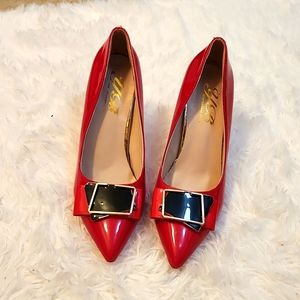 Red Stiletto pointed toe heals with black and gold details at the front.